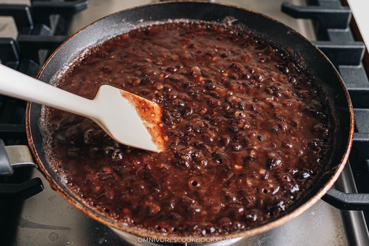 cooked beans, sugar, salt cooking in skillet