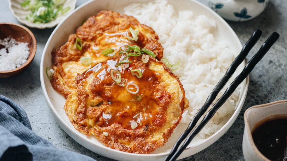 Egg foo young served with rice and veggies with gravy