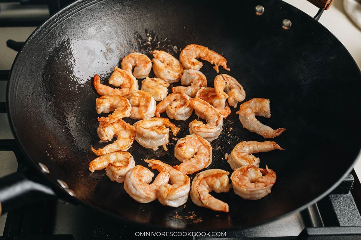 searing the shrimp in a wok
