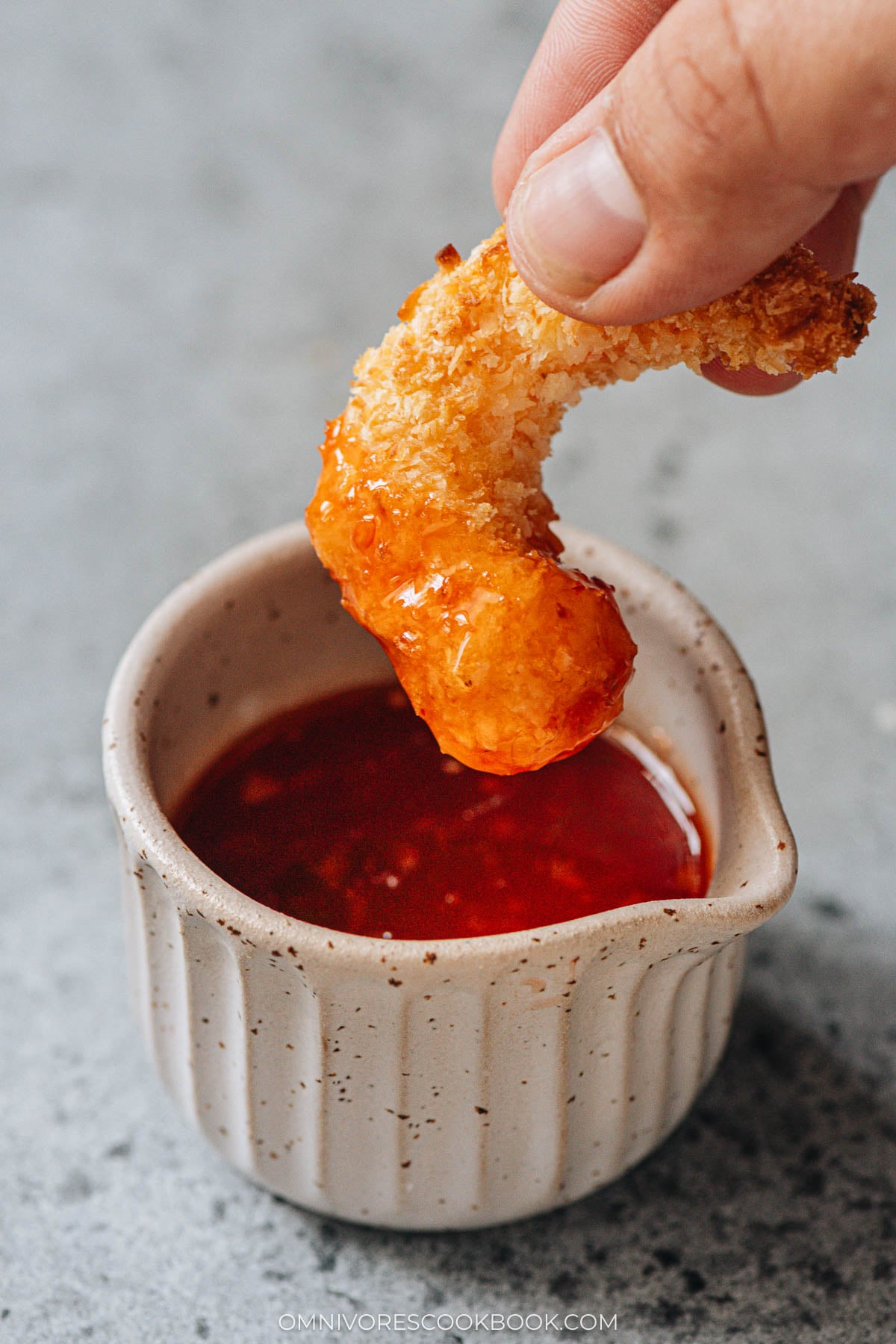 dipping air fryer coconut shrimp in a Thai sweet sauce 