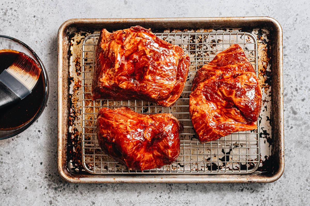 roast pork on a baking tray with a rack
