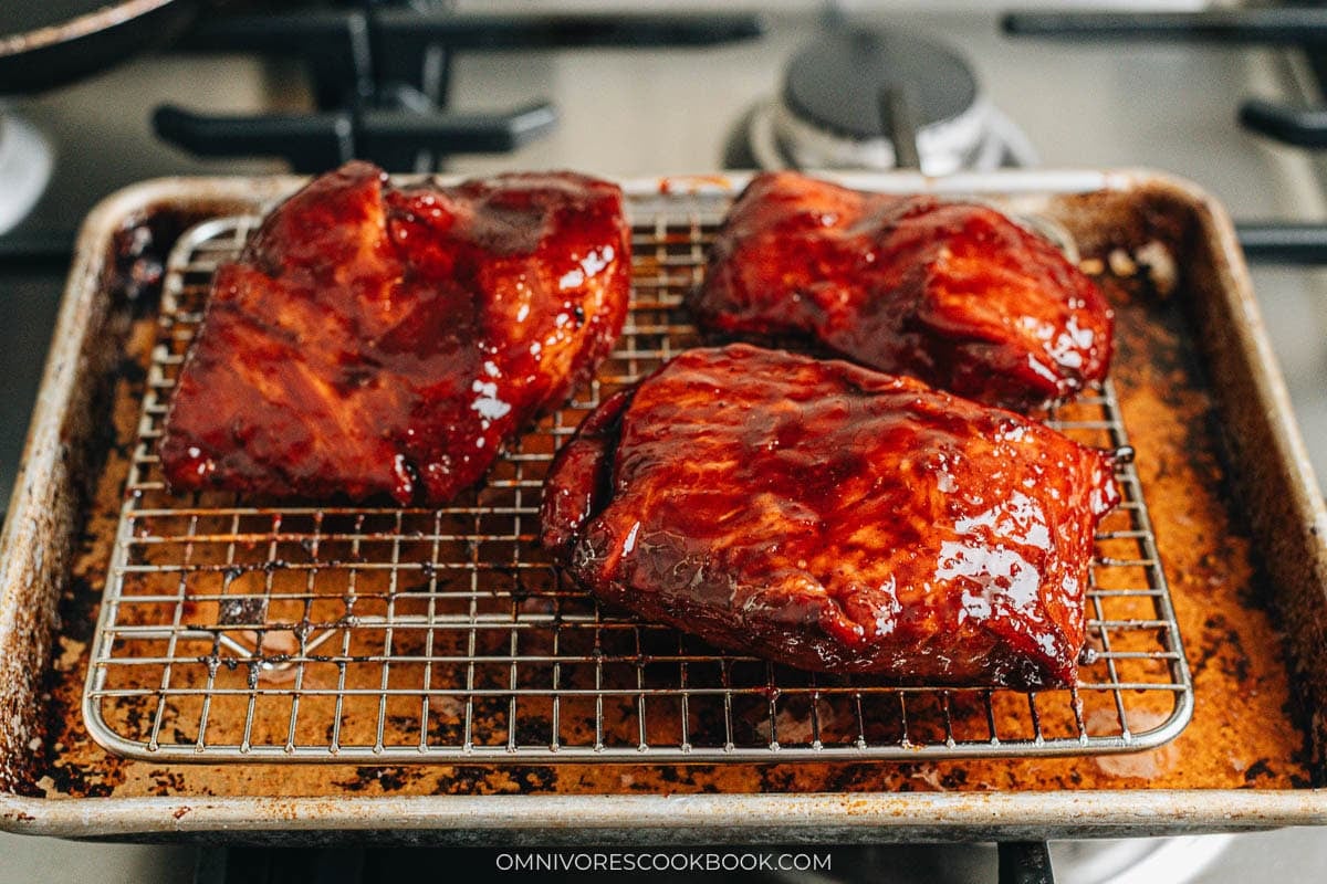 broiled pork on baking tray with a rack