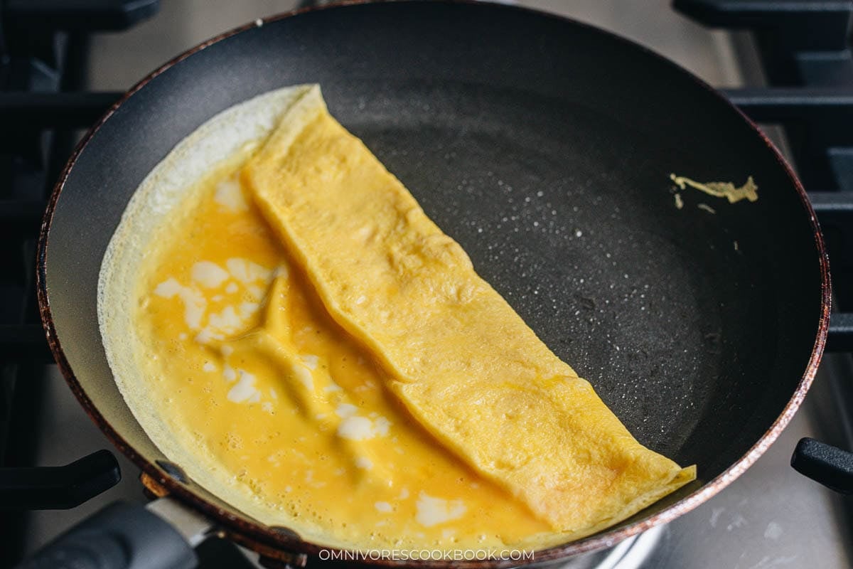 cooking the eggs in a pan