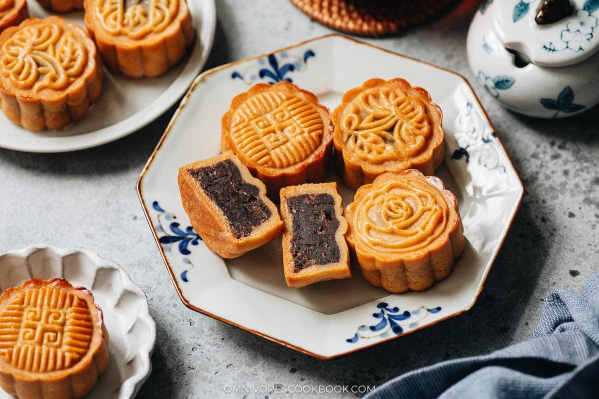Red bean mooncake served in a plate with one cut open