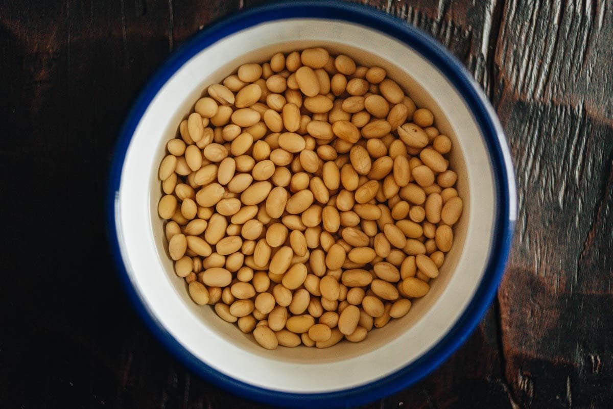 Soy beans soaking in water overnight for smoother soy milk