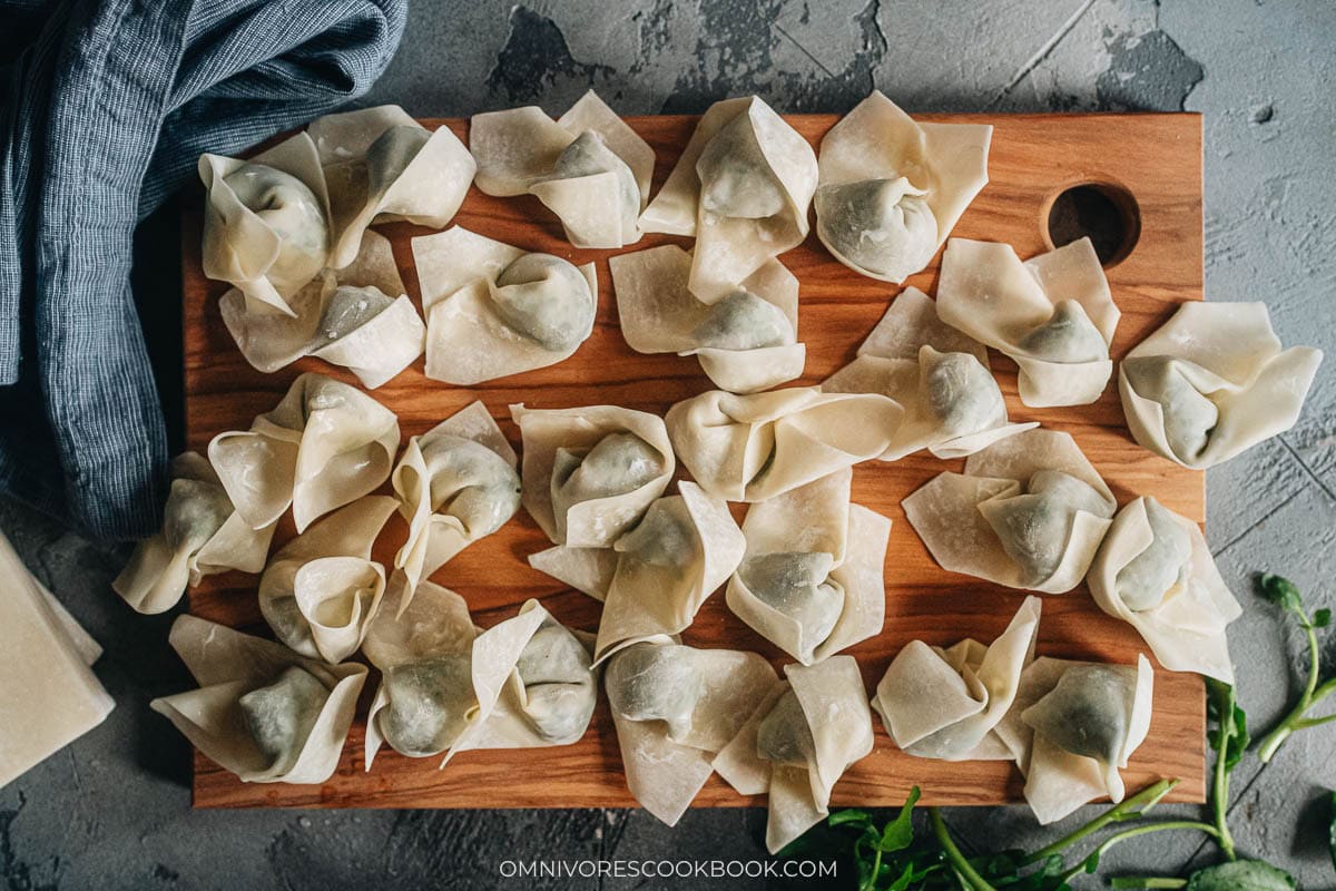 watercress wontons resting on a tray 
