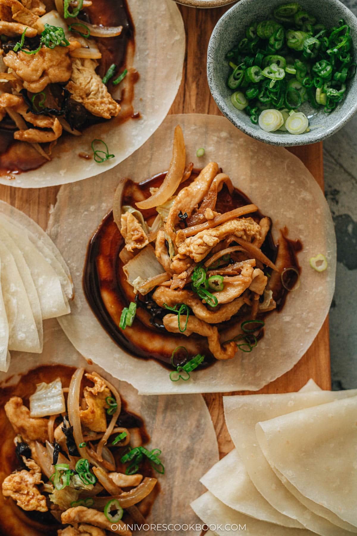 Moo shu chicken plated with steamed pancakes and extra sweet bean sauce
