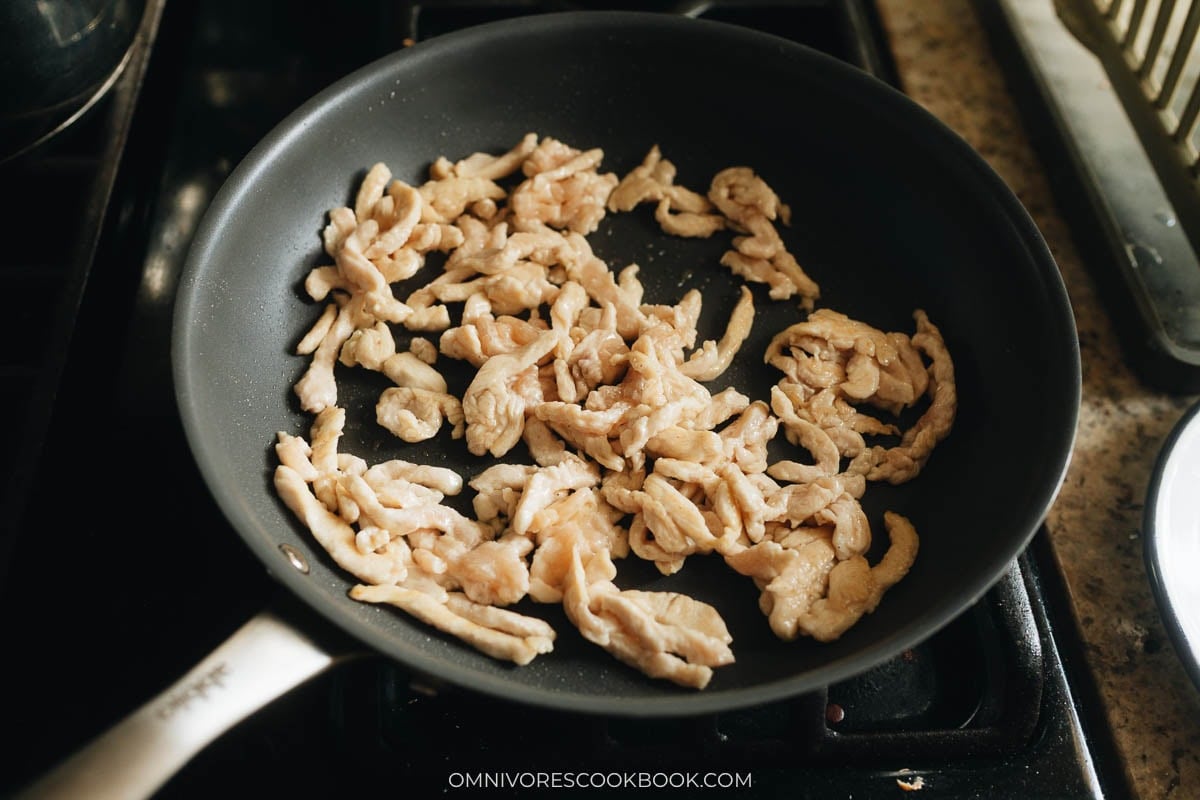 Chicken strips cooking in a nonstick pan