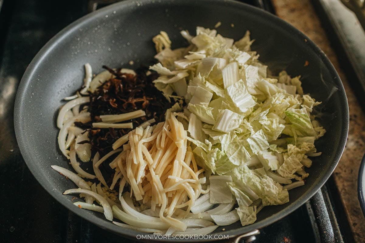 Wood ear mushrooms, bamboo shoots, and napa cabbage cooking 