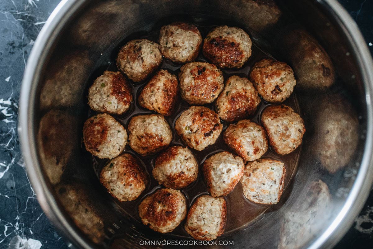 Cornstarch sauce poured over the browned meatballs in the Instant Pot