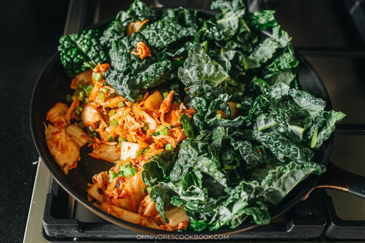 Kale leaves wilting into the kimchi in the pan 