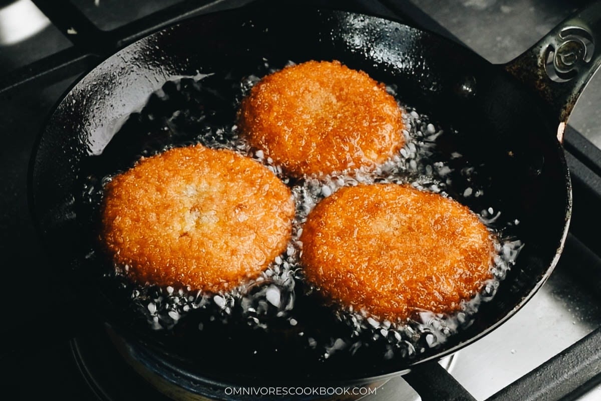 Shallow frying pumpkin cakes until the bottoms go golden brown in a skillet