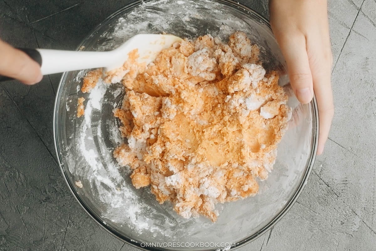 Whisking glutinous rice flour into pumpkin puree to make the pumpkin cake dough