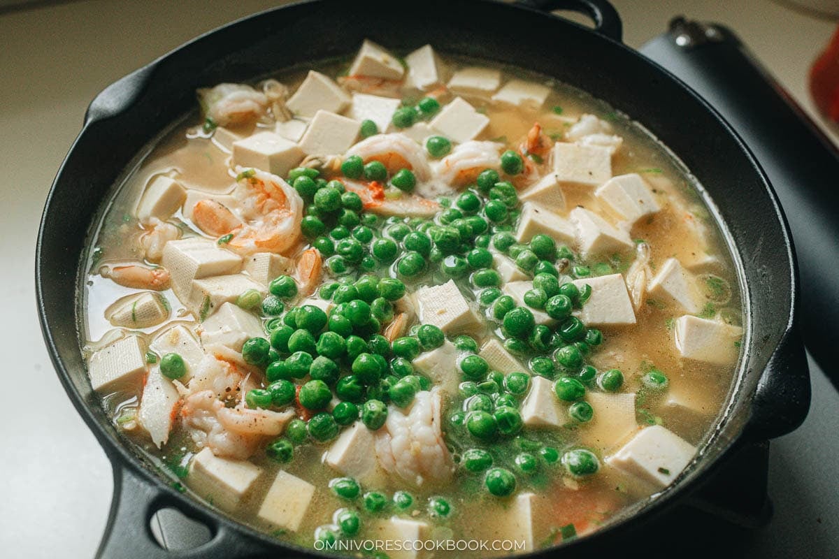 Add the green peas and simmer