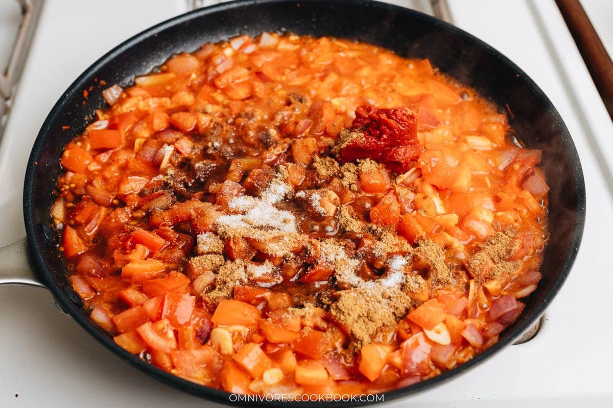 Tomato breaking down into a saucy base with cumin and tomato paste