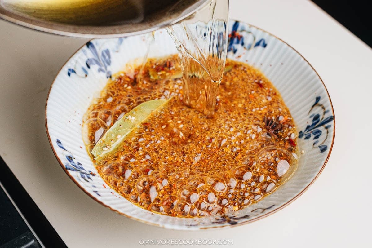 pouring oil over spices