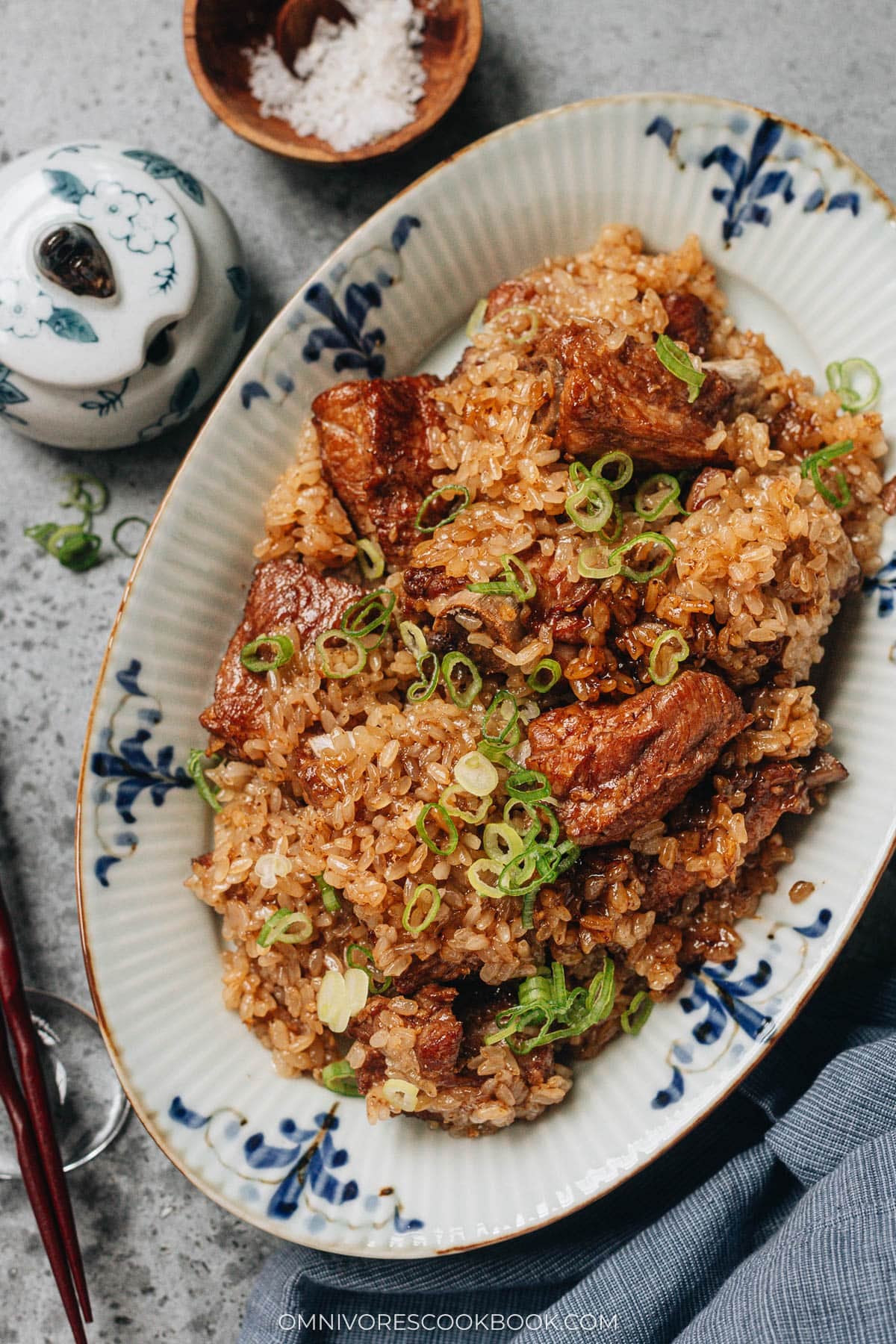 Finished steamed ribs with sticky rice garnished with fresh scallions