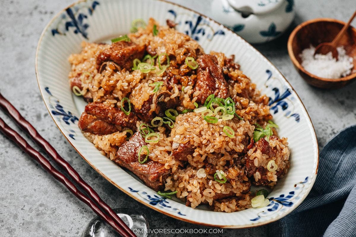 Finished steamed ribs with sticky rice garnished with fresh scallions