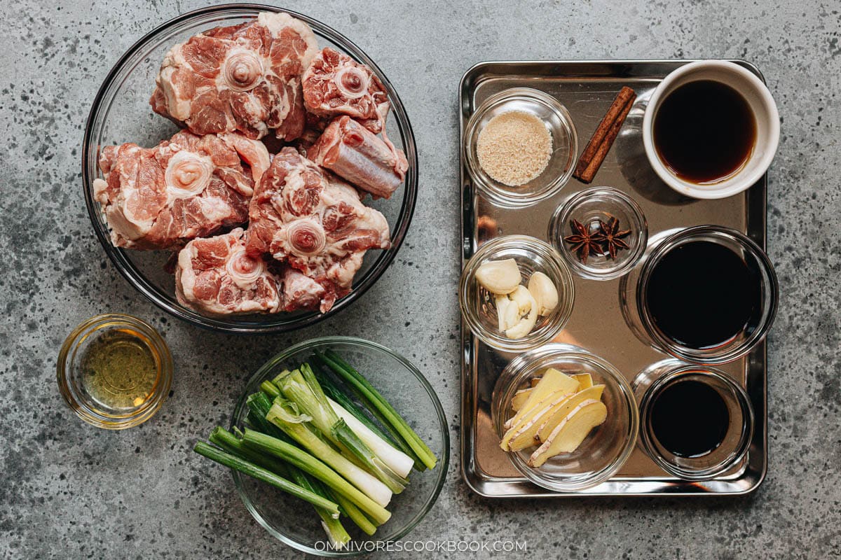 Oxtail pieces, ginger, green onion, star anise, and cinnamon laid out for Chinese braised oxtail