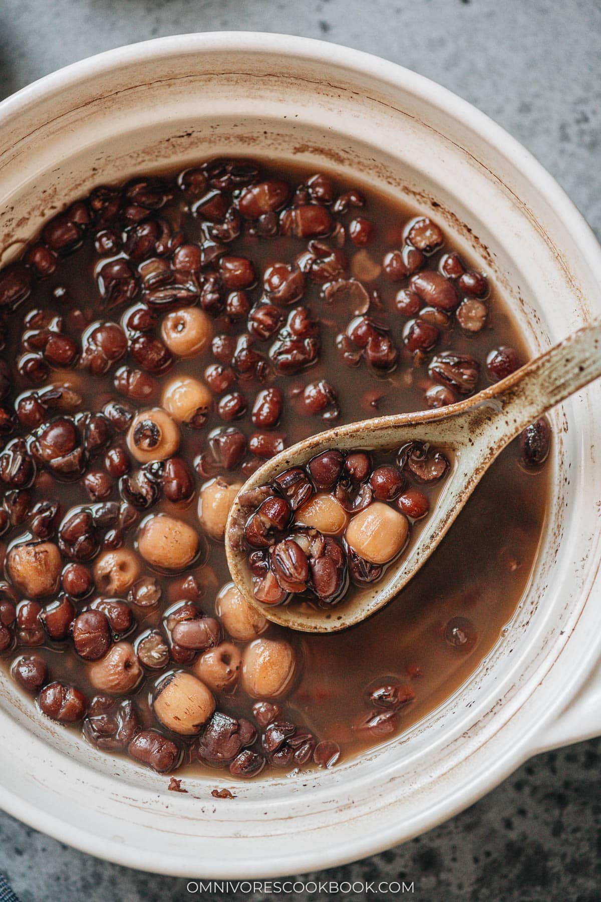 A bowl of warm red bean soup with tender azuki beans i
