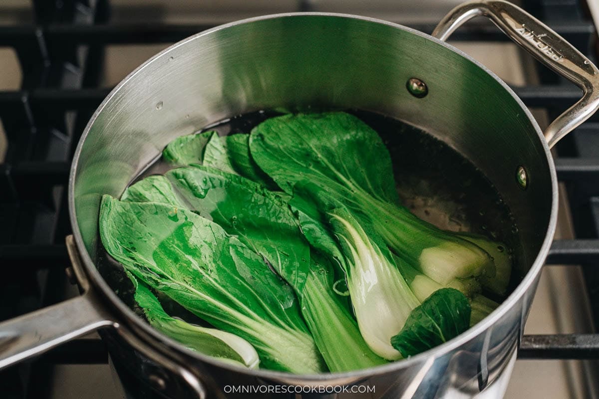 Baby bok choy blanching in boiling water