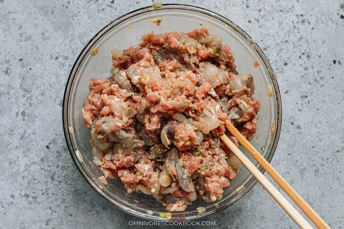 Mixing the pork and shrimp wonton filling with chopsticks until well combined
