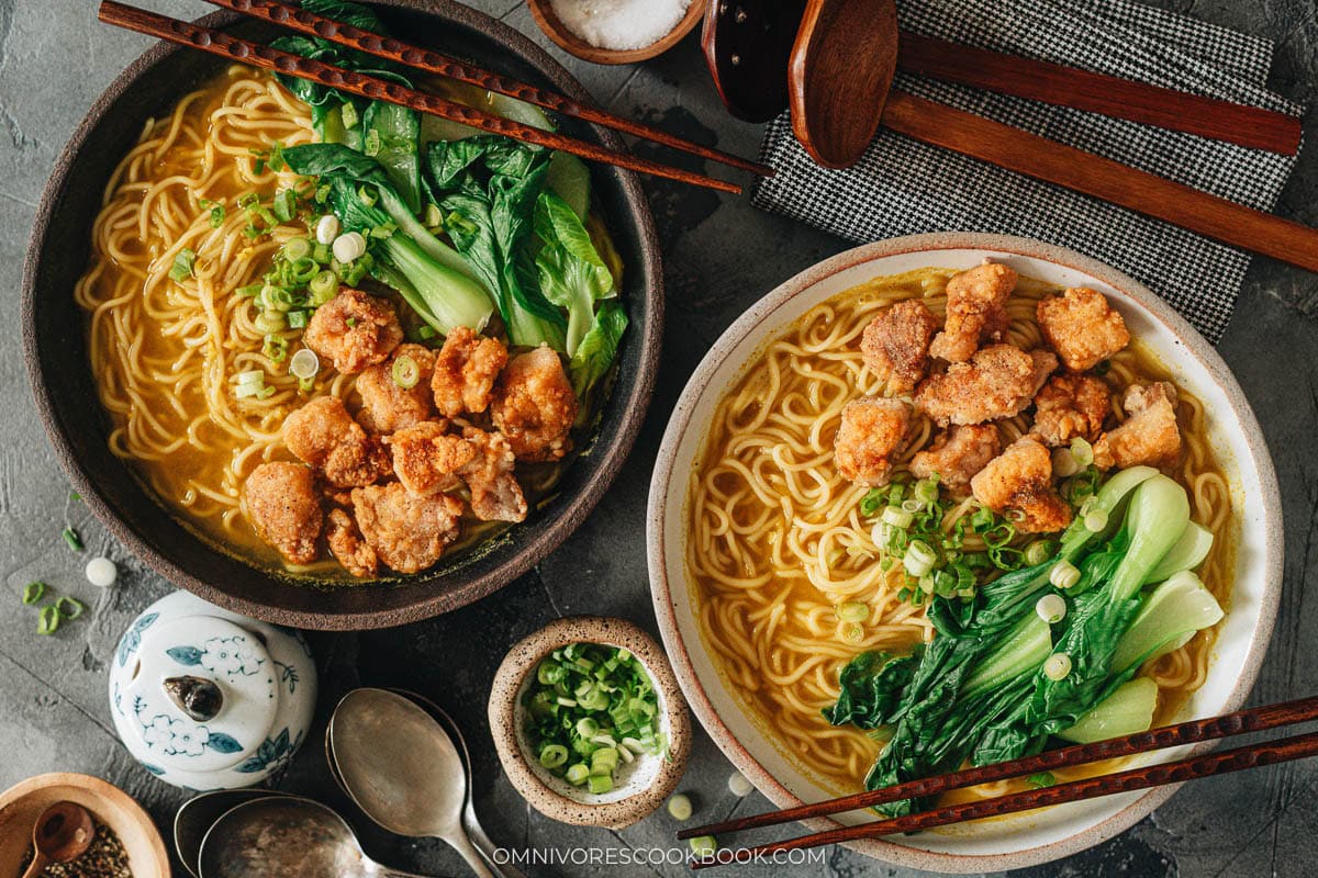 Assembling curry noodle soup with noodles, bok choy, and popcorn chicken
