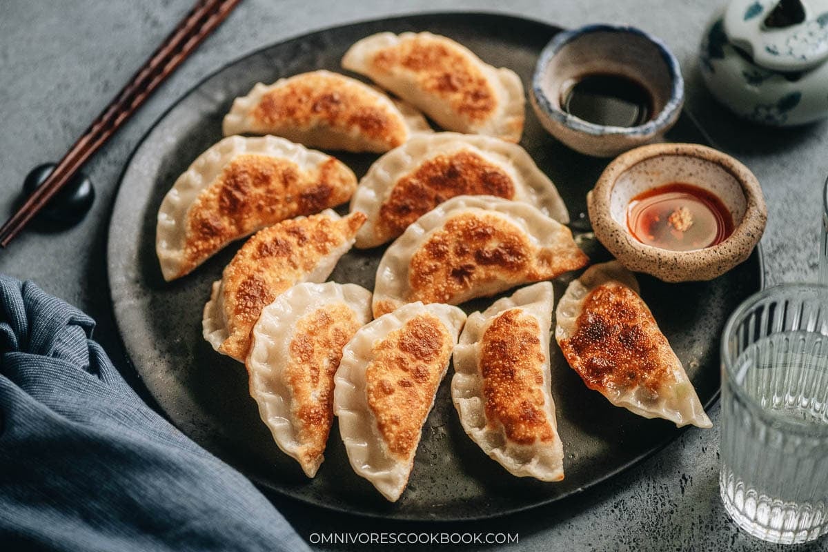 gg and pepper dumplings pan frying until the bottoms are golden
