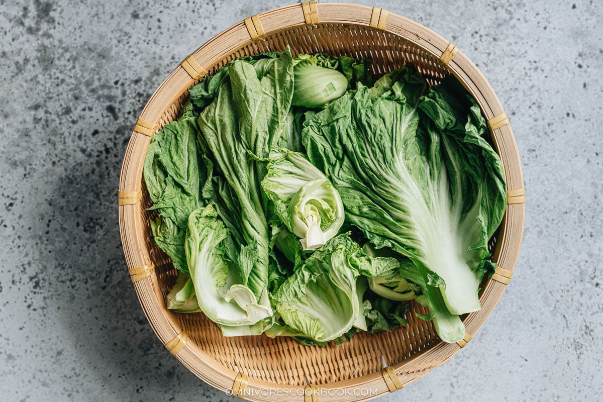 Wilted mustard greens air drying in a sunny spot until the leaves go lim
