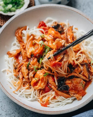 Chinese noodle sauce da lu mian ladled over wide wheat noodles
