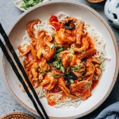 Chinese noodle sauce da lu mian ladled over wide wheat noodles